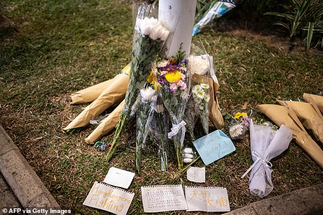 Flowers and messages are left at the aftermath of a major fire that swept through several apartment blocks at the Wang Fuk Court residential estate in Hong Kong's Tai Po district on November 28, 2025