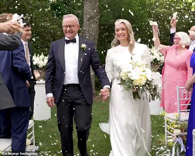 Albanese's son, Nathan, is seen back left smiling as his father marries Jodie Haydon