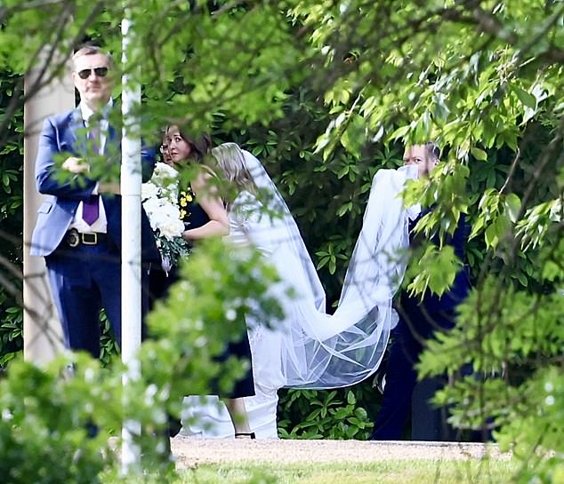 The bride wore a long-sleeved dress and veil
