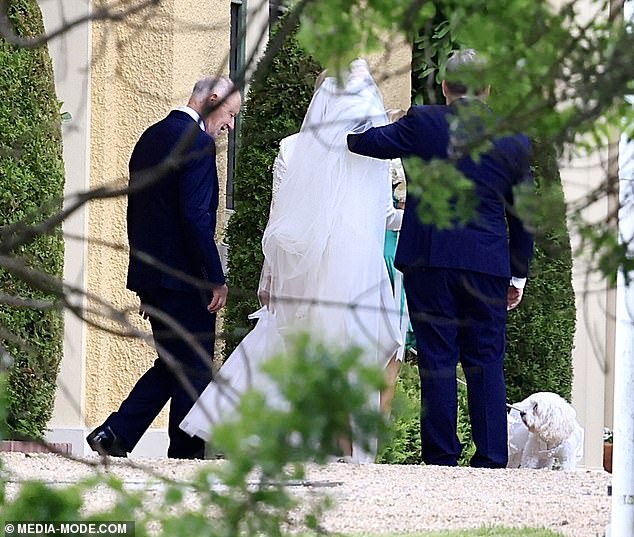 Jodie Haydon is helped by guests as the couple's dog Toto watches on