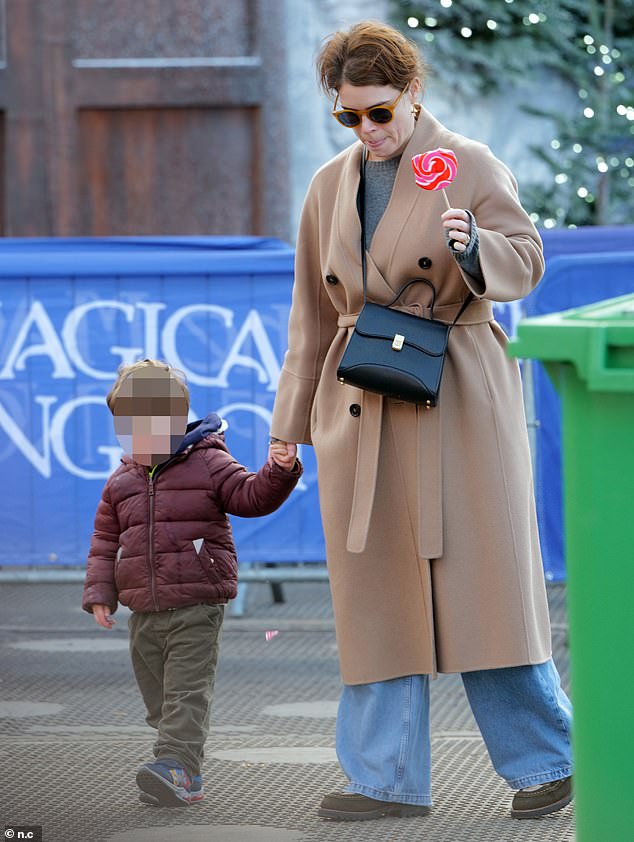 Princess Beatrice 's sister was in jovial mood as she clutched her youngest son by the hand while enjoying a giant red and pink swirl lollipop