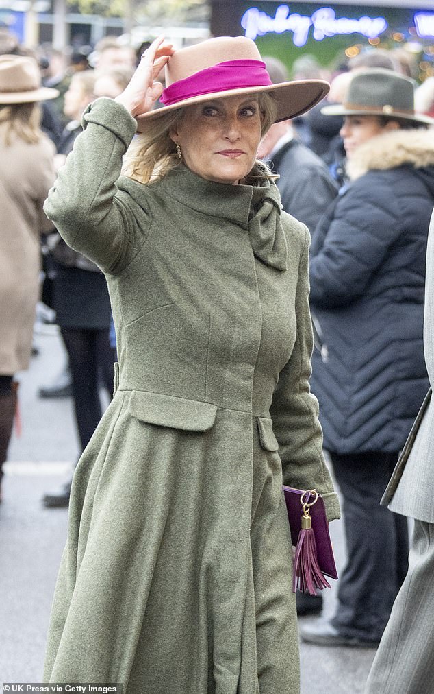 Sophie donned a full length green tweed coat, tan boots and wide-brimmed hat with pink ribbon