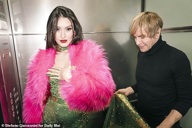 Bouwer is seen with model Sabrina Perlleshi wearing one of his gowns