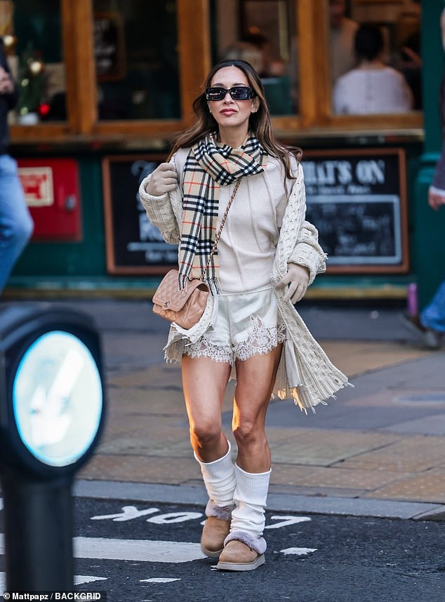 Flaunting her toned legs, Myleene rocked cream leg warmers and comfortable fuzzy shoes