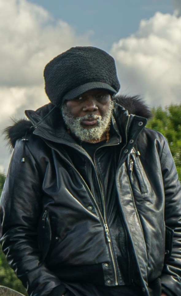 Franklin Francis wearing a black hat and jacket with a fur collar.