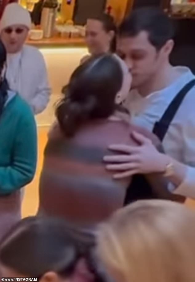 After she completed the task of putting a diaper on the stuffed animal, she turned around as Pete cheered her on and the couple shared a loving kiss