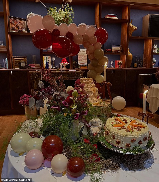The yummy dessert was placed on a circular table decorated with fake moss and grass, while a stuffed bunny was set on top