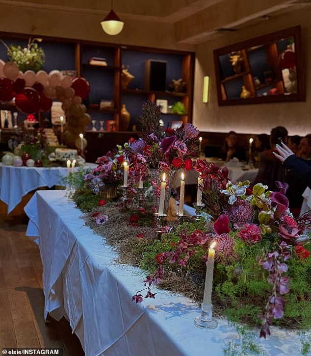 Another table was set aside for gifts while more were covered with fake moss, grass, floral decorations and white candles in the middle of the room