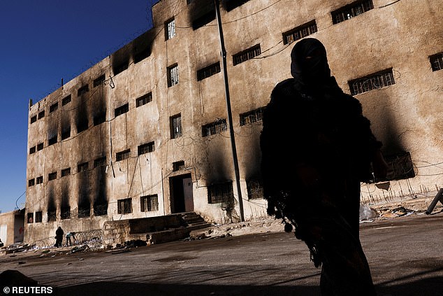 A woman walks past Sednaya prison in Sednaya, Syria, December 19, 2024