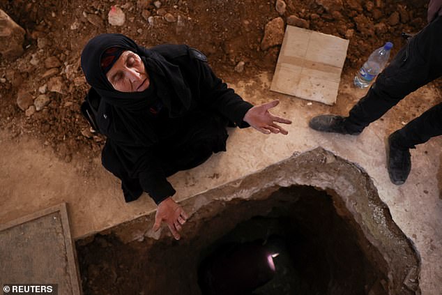 A woman reacts as relatives dig up the floor in Sednaya prison to look for her son, December 17, 2024