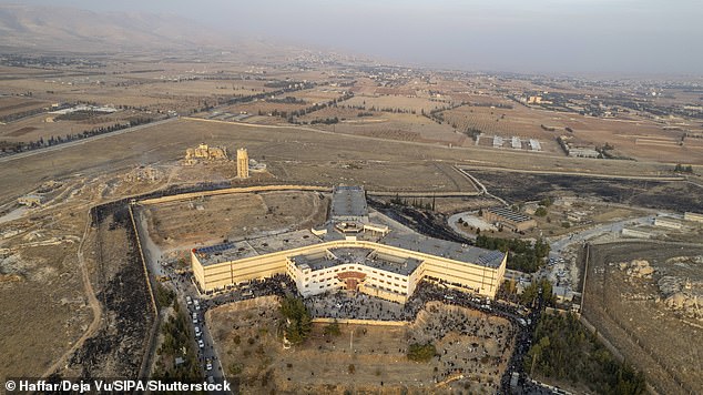 An aerial photo shows people gathering at the Sednaya prison in Damascus on December 9, 2024