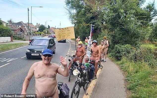 A group of naturists ride on their bikes during a nude charity bike ride