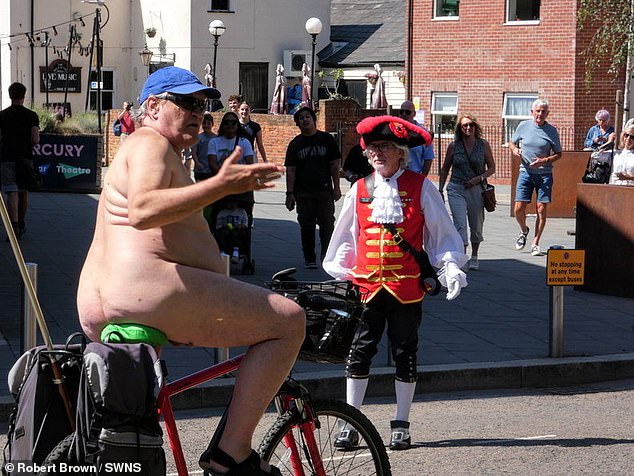 Mr Brown is seen naked on his bike in public wearing only a blue baseball cap