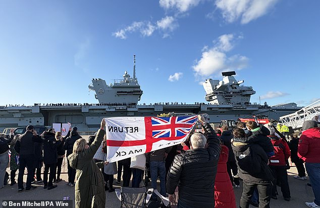 Friends and family wave as HMS Prince of Wales returns to Portsmouth Naval Base at the end of her eight-month deployment with the Carrier Strike Group (CSG25), known as Operation Highmast, on Sunday November 30, 2025.