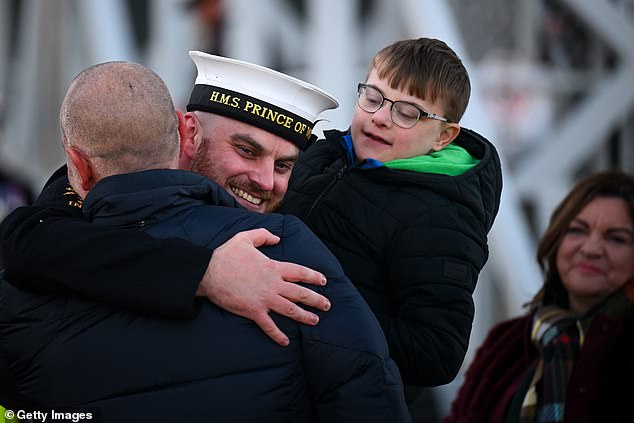 Sailor of the Year, Joseph Mellor is first to disembark after HMS Prince of Wales aircraft carrier arrives at Portsmouth Naval Base, on November 30, 2025 in Portsmouth, England