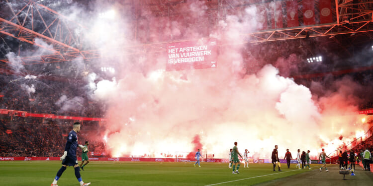 Ajax clash abandoned as huge fireworks display erupts in stands and referee unable to guarantee player safety