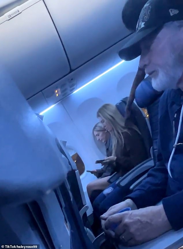 Before removing the woman, flight staff made sure the two other females sitting in her row got up and out of the way