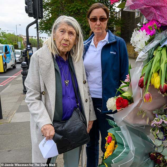 Helen's sister Dorothy, who she was visiting just before the collision occurred, with Helen's daughter-in-law Lisa, placing flowers on West Cromwell Road in May 2023