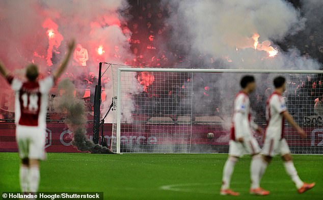 Ajax players begin to walk off, with Davy Klaassen appearing to remonstrate with supporters