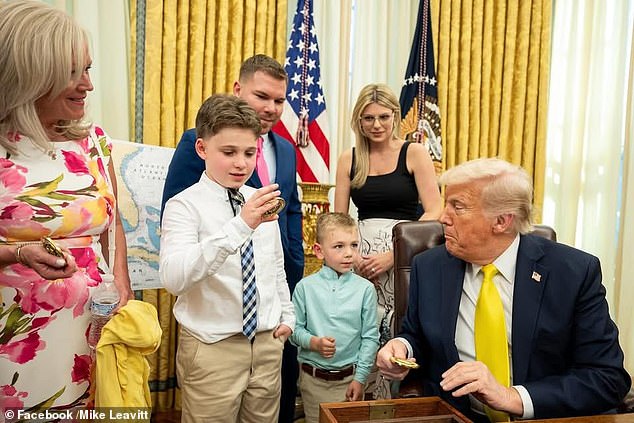 Michael Sr said the 11-year-old boy lives with him and his wife full-time (pictured with Trump), but has always maintained a relationship with his biological mother