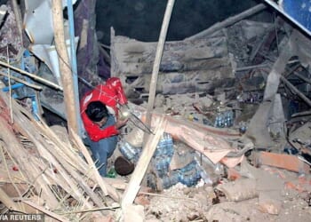 A rescuer works following an earthquake at an unidentified location in Afghanistan, in this handout image released November 3, 2025