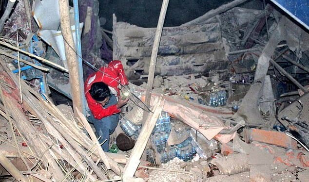 A rescuer works following an earthquake at an unidentified location in Afghanistan, in this handout image released November 3, 2025