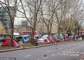 Tents and wooden pallets clutter the pavement next to the busy Euston Road in north London
