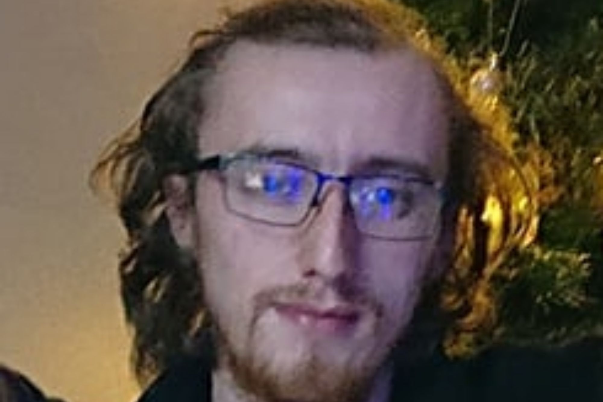 An image collage containing 1 images, Image 1 shows Photo of Sean Middleborough, a Palestine Action activist, wearing glasses, a beard, and a t-shirt with a hammer and sickle design