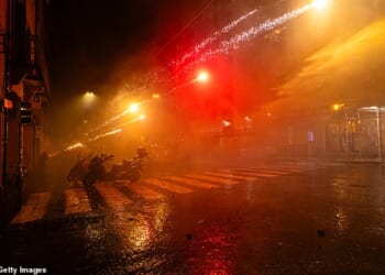 Pro-Palestinian supporters shoot fireworks at police during a protest near the Virtus Arena on November 21, 2025 in Bologna, Italy