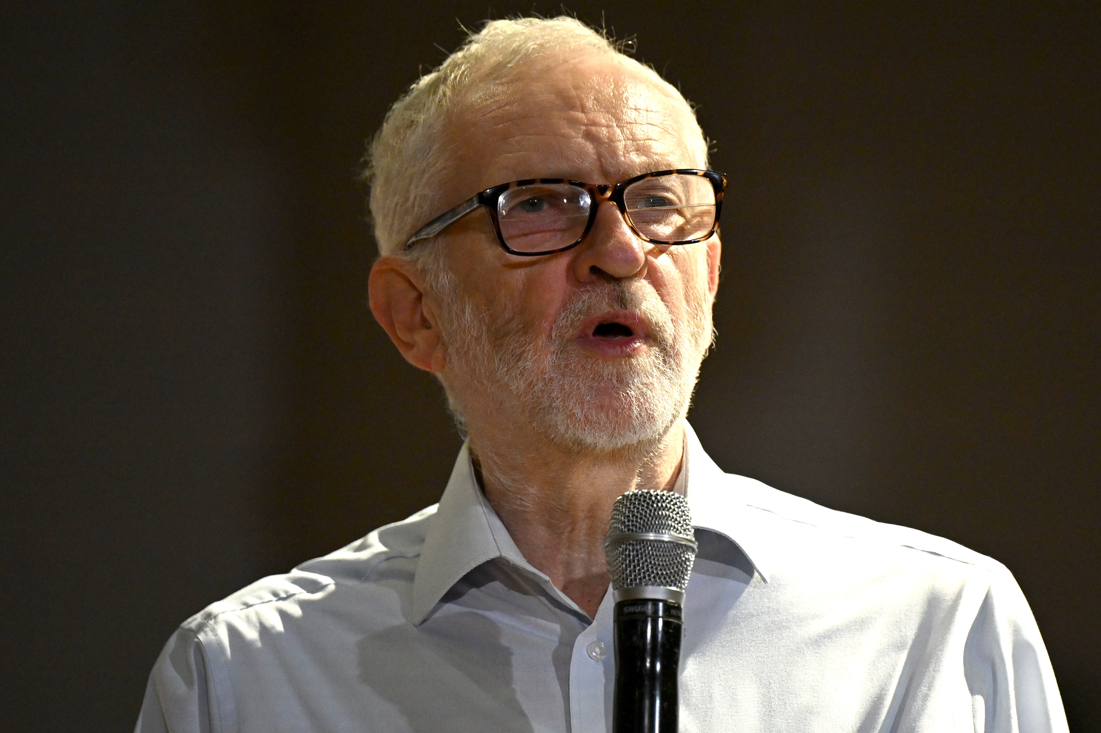 Jeremy Corbyn speaking into a microphone.