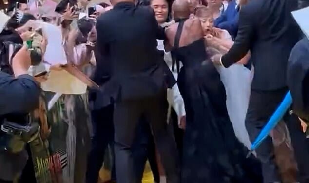 Ariana Grande was ambushed by an overzealous fan while walking the red carpet at the Singapore premiere of her new film Wicked: For Good on Thursday