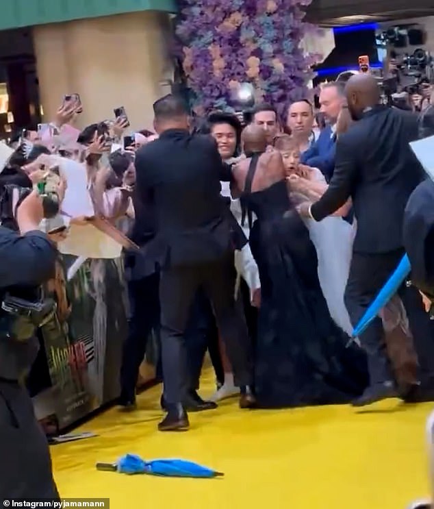Ariana Grande was ambushed by an overzealous fan while walking the red carpet at the Singapore premiere of her new film Wicked: For Good on Thursday