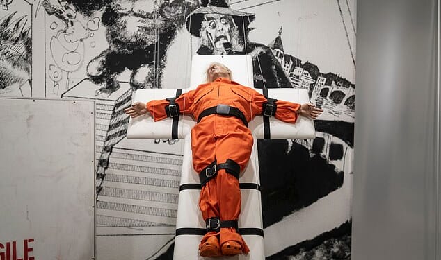 Artwork showing President Donald Trump strapped to a cross-shaped gurney in a prison uniform has popped up in Basel, Switzerland