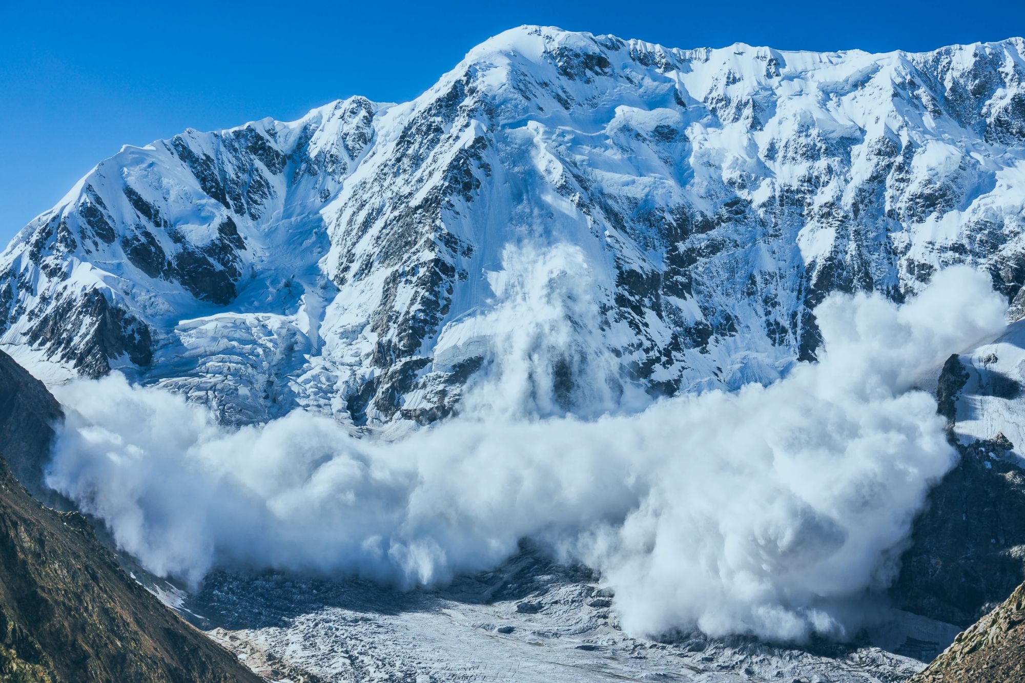 An image collage containing 1 images, Image 1 shows Large avalanche coming down the rocky Caucasus mountain