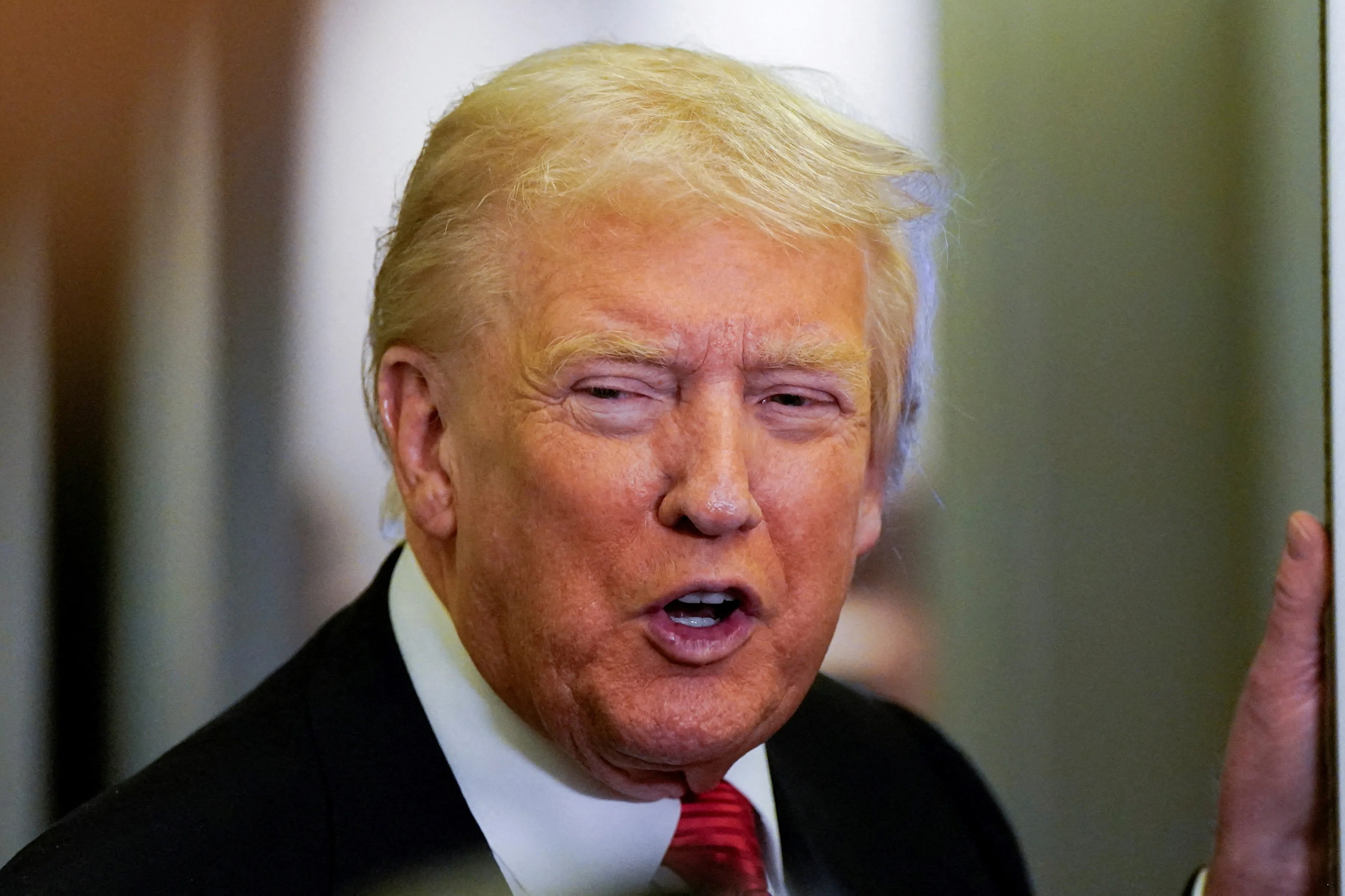 U.S. President Donald Trump speaks to members of the media on Air Force One.