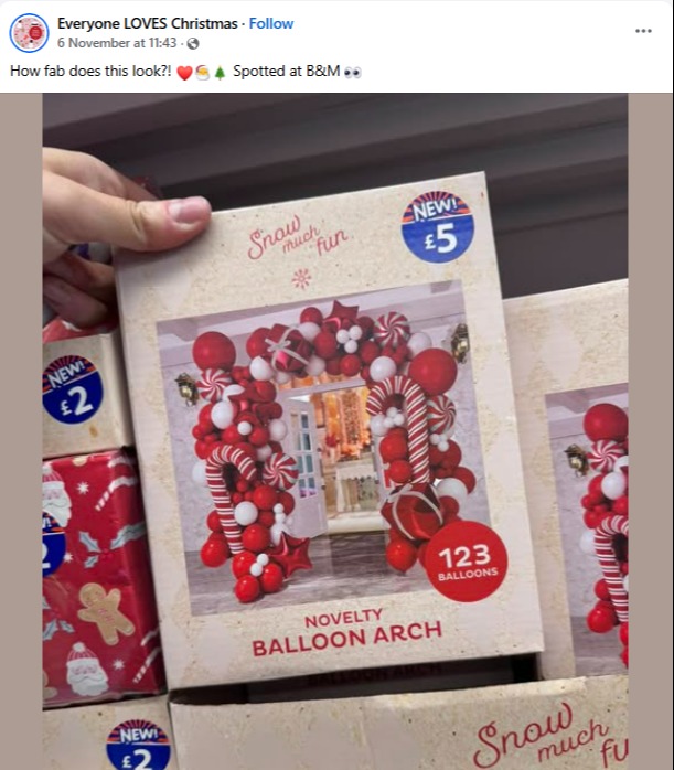 Boxed novelty balloon arch with red and white balloons shaped like candy canes and round ornaments.