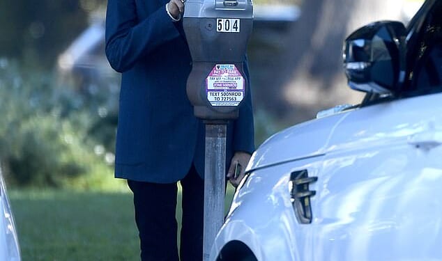 Lovely Barbara feeds the meter in Beverly Hills during a trip into town for a meeting