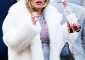 A reveller with a bottle of wine on the streets of Swansea marking Beaujolais Nouveau Day