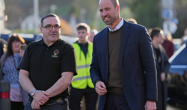 The Prince of Wales walks with Scott Jenkinson, the founder of Youth Shedz during a visit to its headquarters in Conwy