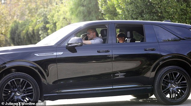 He was seen motoring there this Thursday with Samuel sitting in the back - and a blonde mystery woman in the front passenger seat