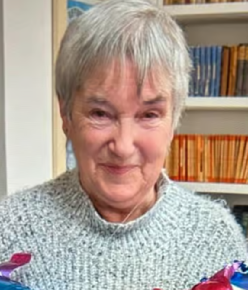 Elaine, a woman with short gray hair, wearing a gray knitted sweater.