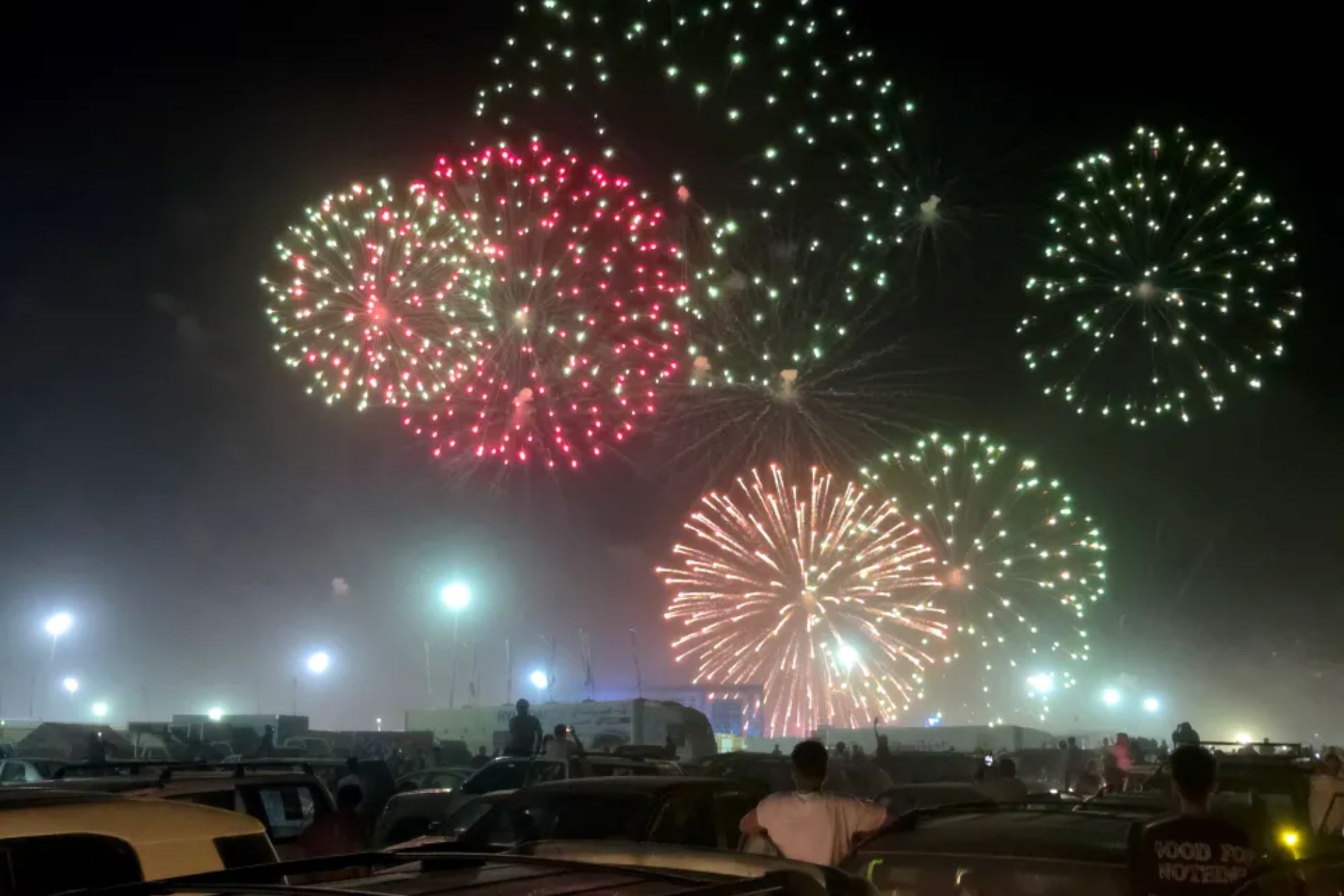 An image collage containing 1 images, Image 1 shows Fireworks light up the night sky at the end of the second stage of the 2025 4x4 Tete Desert Rally in Waddan, Libya