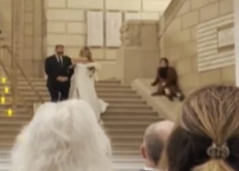 A wedding planner appeared to upstage a bride on her big day by sliding down the stairs