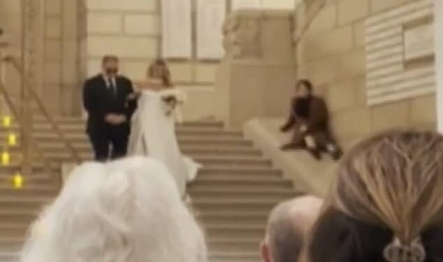 A wedding planner appeared to upstage a bride on her big day by sliding down the stairs