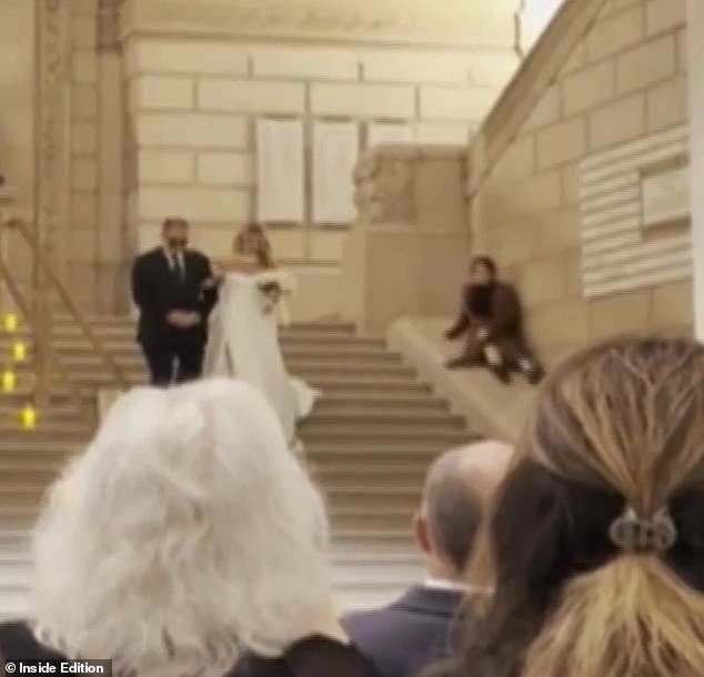 A wedding planner appeared to upstage a bride on her big day by sliding down the stairs
