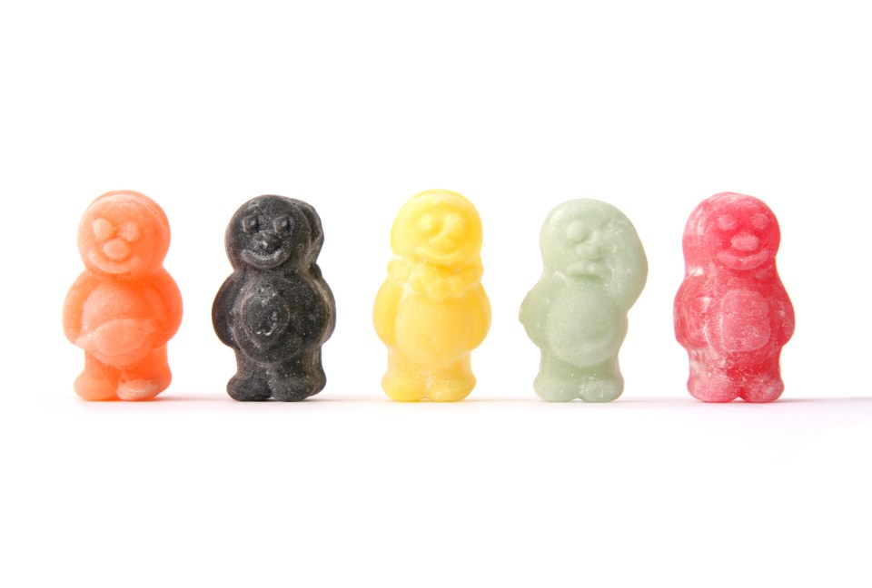 Five colorful jelly babies on a white background
