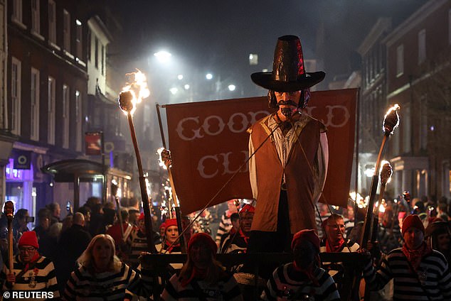 Pictured: an effigy of Guy Fawkes is paraded through the town in Lewes