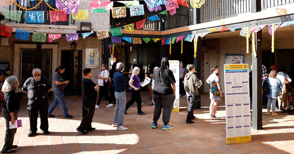 Voters wait in line to enter a polling place in Los Angeles, California, on Tuesday.