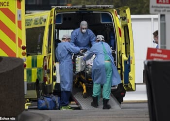Paramedics take a patient into St Thomas' Hospital during the Covid 19 pandemic in 2020