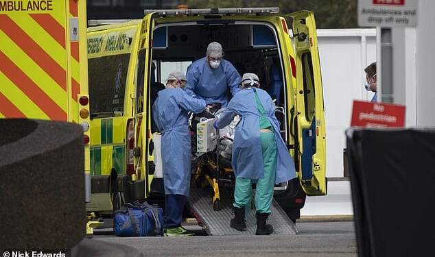 Paramedics take a patient into St Thomas' Hospital during the Covid 19 pandemic in 2020